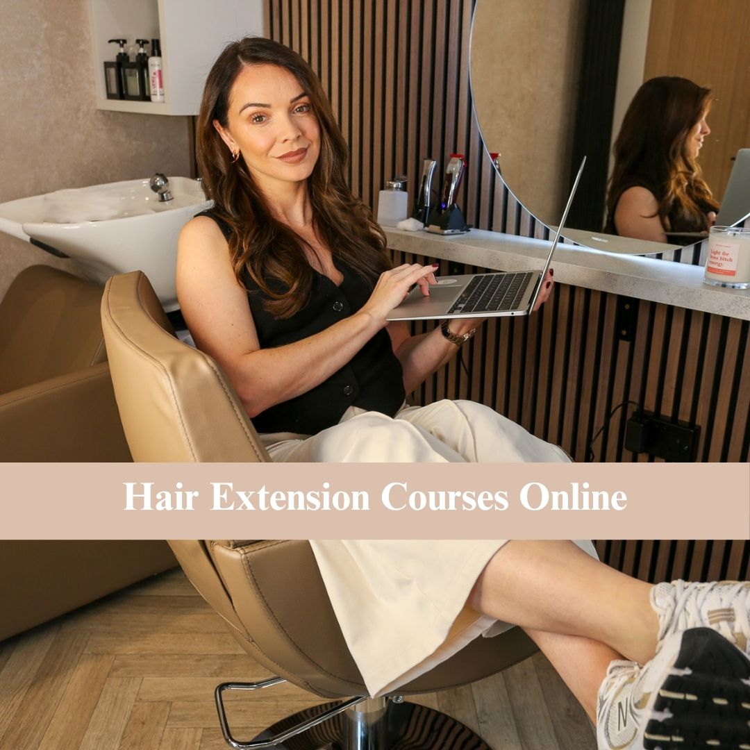 Danielle Alexandra hair extension educator holding a laptop at By Danielle Alexandra Academy