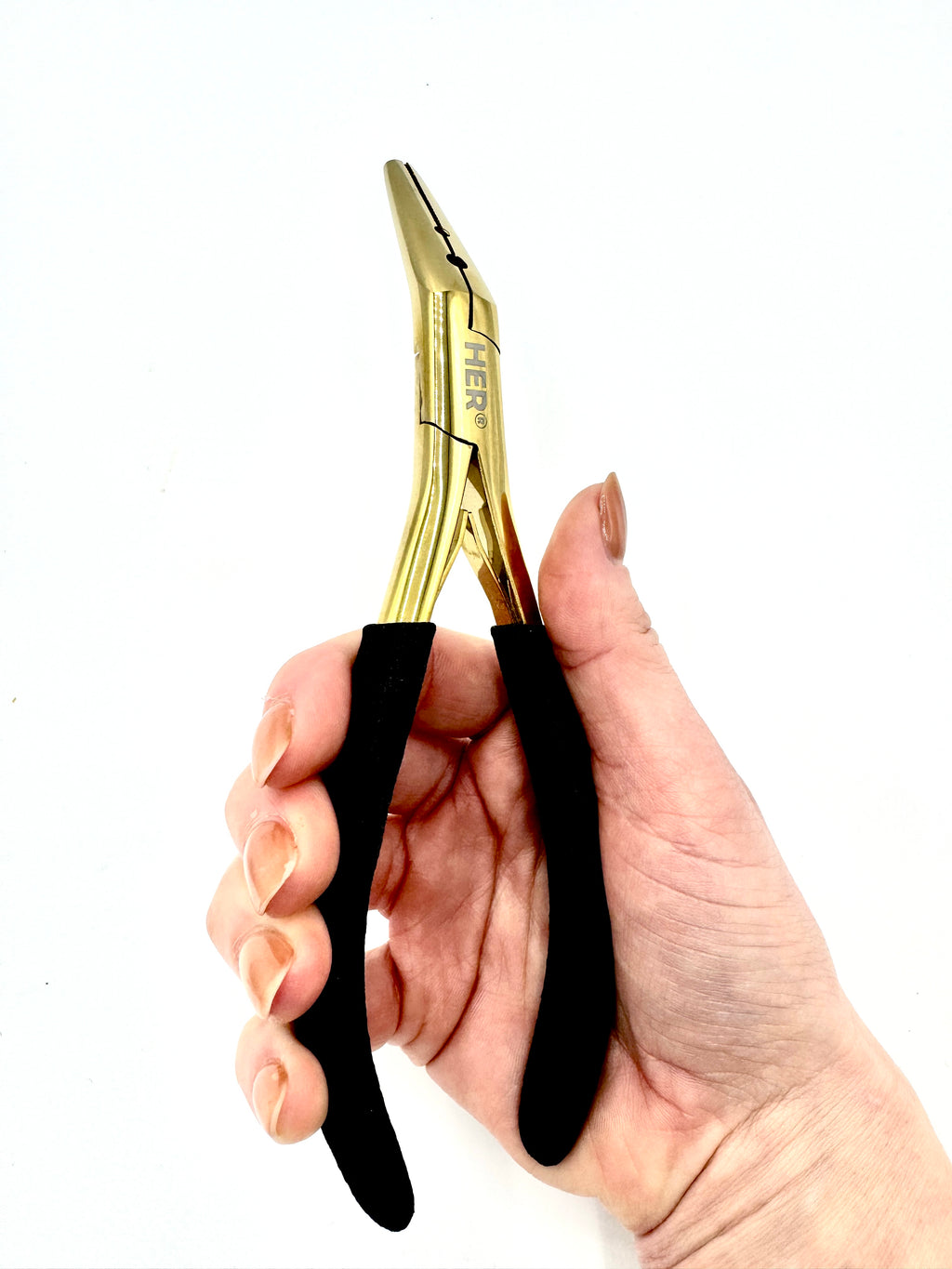 Hand holding a pair of gold pliers with black handles on a white background