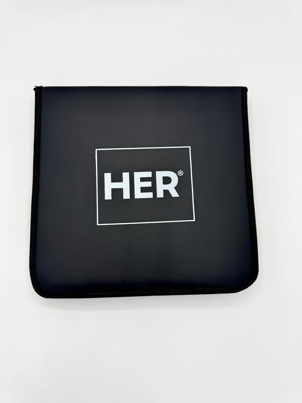 Black pouch with 'HER' logo on a white background